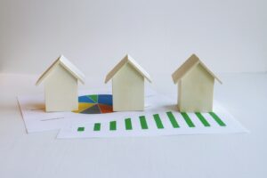 three small houses sitting on top of a piece of paper